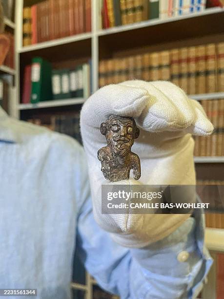 Denmark's national museum curator Peter Pentz shows a gaming piece which is believed to be the first portrait of a Viking, on August 26, 2025 in...