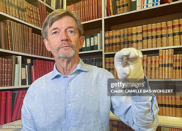 Denmark's national museum curator Peter Pentz shows a gaming piece which is believed to be the first portrait of a Viking, on August 26, 2025 in...