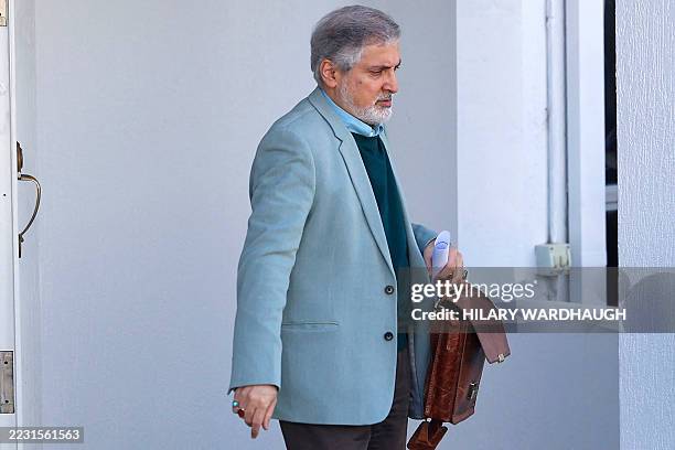 Iranian Ambassador to Australia Ahmad Sadeghi walks toward his car within the grounds of the Islamic Republic of Iran's embassy in Canberra on August...