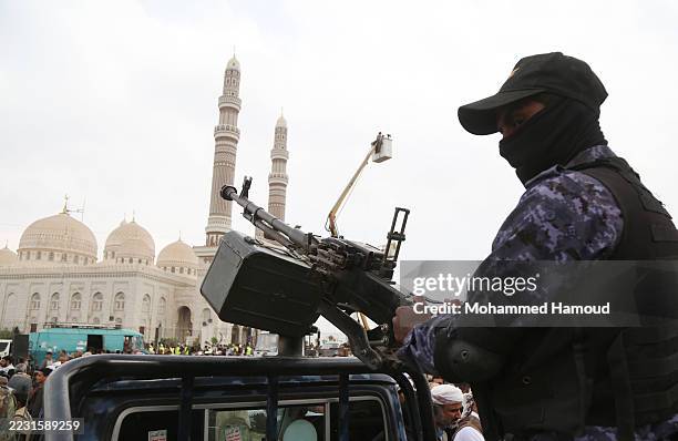 Yemeni security soldier mans a machine gun mounted on a vehicle during a protest staged in support of Gaza on August 22, 2025 in Sana'a, Yemen.
