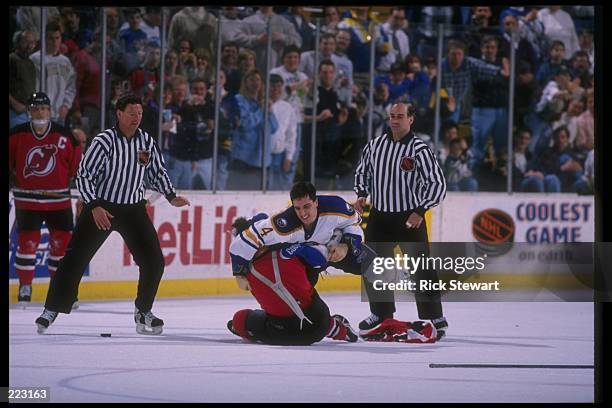 Defenseman Bob Boughner of the Buffalo Sabres fights a New Jersey Devils player during a game at Memorial Auditorium in Buffalo, New York. The game...