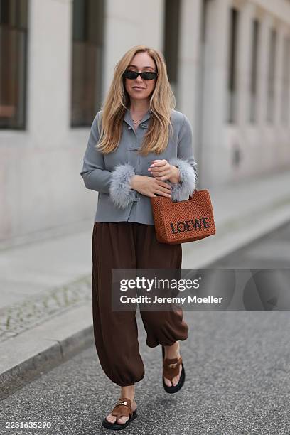 Sonia Lyson seen wearing Linda Farrow black slim rectangular sunglasses, Daily Sleeper light grey jacket featuring light grey feather trim at the...