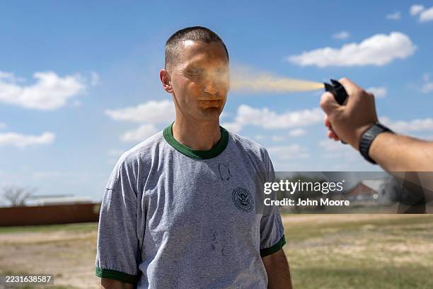 Border Patrol instructor shoots pepper spray into the face of a recruit during a training scenario at the U.S. Border Patrol Academy on August 22,...