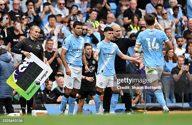 Rodri of Manchester City and teammate Phil Foden are brought on as substitutes during the Premier League match between Manchester City and Tottenham...