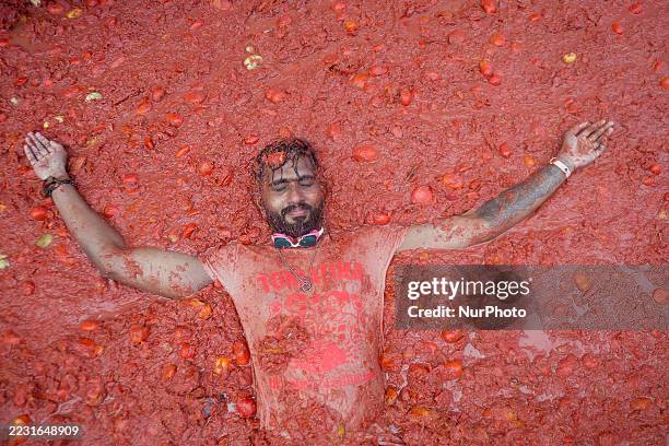 People covered in tomato pulp take part in the 78th 'Tomatina' Festival in Bunol, Spain, on August 27, 2025. They throw a total of 120 tonnes of...