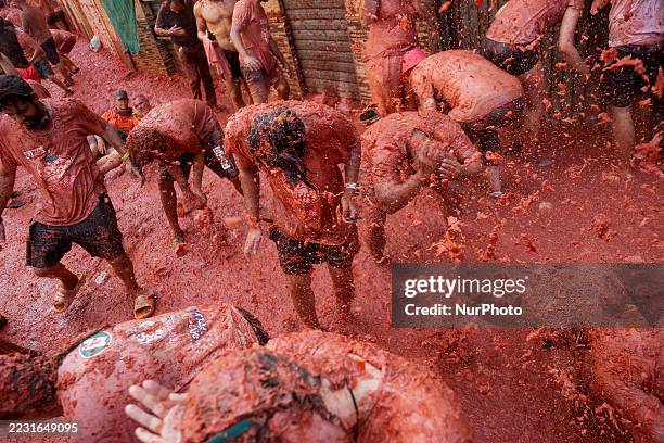 People covered in tomato pulp take part in the 78th 'Tomatina' Festival in Bunol, Spain, on August 27, 2025. They throw a total of 120 tonnes of...