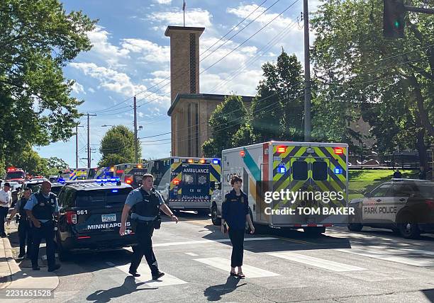 Police and first responders work at the scene of a shooting near Annunciation Church and Catholic School in Minneapolis, Minneosta, on August 27,...