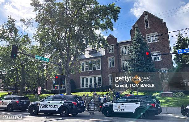 Police and first responders work at the scene of a shooting near Annunciation Church and Catholic School in Minneapolis, Minneosta, on August 27,...