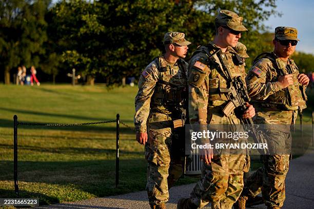 Armed National Guard troops patrol near the Washington Monument on the National Mall in Washington, D.C. On August 26, 2025. On August 11, President...