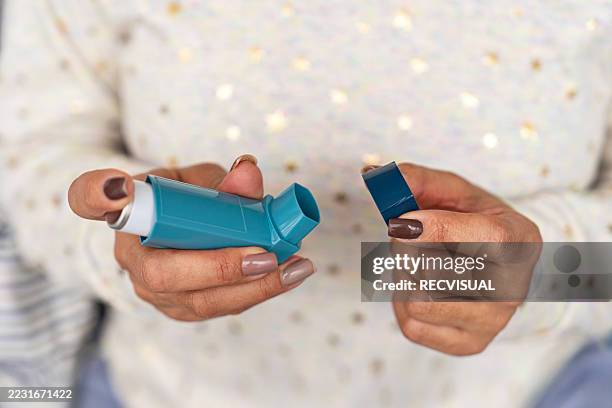 hand holding inhaler for asthma treatment. - asthma inhaler stock pictures, royalty-free photos & images