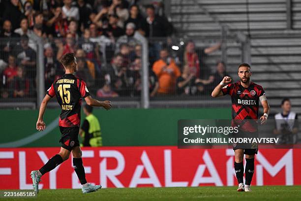 Wiesbaden's German forward Fatih Kaya celebrates scoring the 2-2 goal with his teammate Wiesbaden's German defender Justin Janitzek during the German...