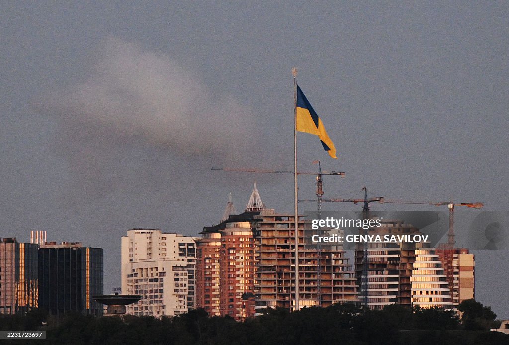 Ukraine High Rises TOPSHOT - A smoke rises behind a giant Ukrainian flag during a... News ...