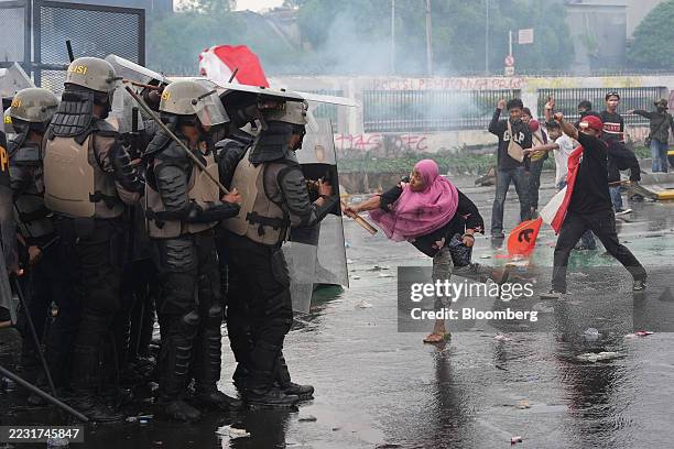 Demonstrators clash with riot police during a protest outside the parliament building in Jakarta, Indonesia, on Thursday, Aug. 28, 2025. Workers...