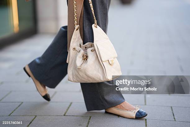 Patricia Wirschke is seen wearing grey elegant Rossi hose; Chanel bicolor black and beige ballet flats, with an embroidered logo on top of the tip of...