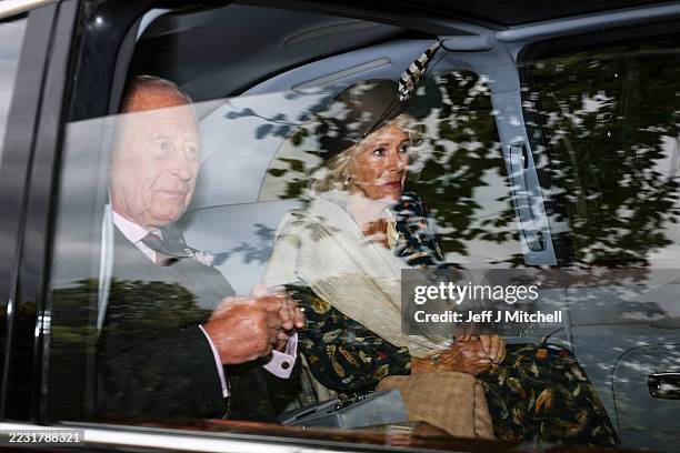 King Charles III and Queen Camilla arrive by car at Crathie Kirk to attend the church service at Crathie Kirk Church on August 24, 2025 in Crathie,...