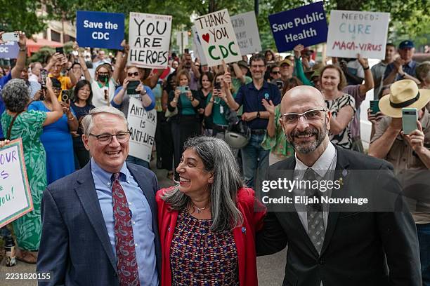 Former Centers for Disease Control officials Dan Jernigan, Deb Houry, and Demetre Daskalakis smile as employees and supporters of the CDC line up...