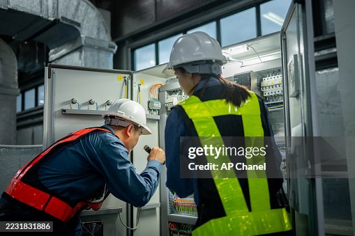 Industrial technicians working electrical control cabinet panel is well-organized for manufacturing, HVAC, or power distribution and organized technical environment. Industrial technicians working electrical control cabinet panel is well-organized for manufacturing, HVAC, or power distribution and organized technical environment.