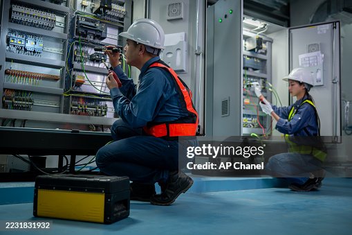 Industrial technicians working electrical control cabinet panel is well-organized for manufacturing, HVAC, or power distribution and organized technical environment. Industrial technicians working electrical control cabinet panel is well-organized for manufacturing, HVAC, or power distribution and organized technical environment.