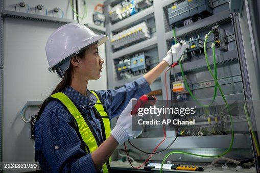 Industrial technicians working electrical control cabinet panel is well-organized for manufacturing, HVAC, or power distribution and organized technical environment. Industrial technicians working electrical control cabinet panel is well-organized for manufacturing, HVAC, or power distribution and organized technical environment.