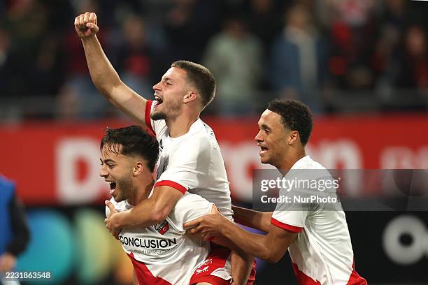 Souffian El Karouani, Dave van den Berg, and Adrian Blake of FC Utrecht celebrate after reaching the Europa League following the match between FC...
