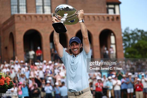 Tommy Fleetwood of England celebrates with the Fedex Cup trophy after winning the final round of the TOUR Championship 2025 at East Lake Golf Club on...