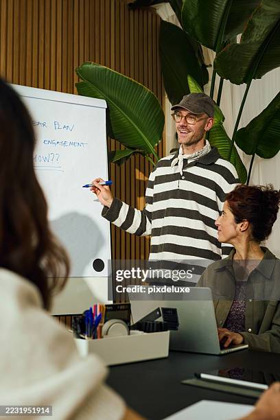 diverse team discussing five year plan for increasing engagement in modern office - topics stock pictures, royalty-free photos & images