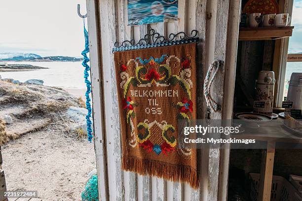 rustic cabin door with welcome tapestry - olden norway stock pictures, royalty-free photos & images