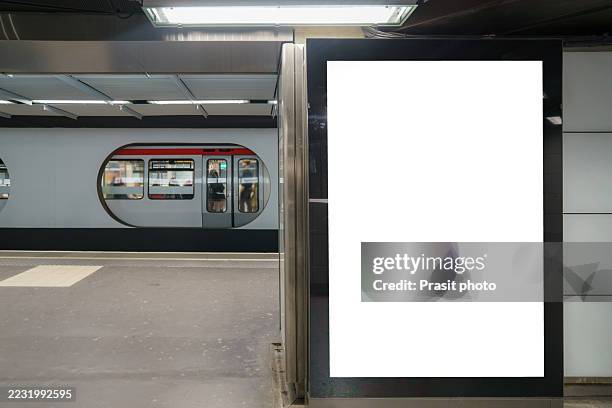 blank illuminated billboard on metro platform - subway platform poster stock pictures, royalty-free photos & images