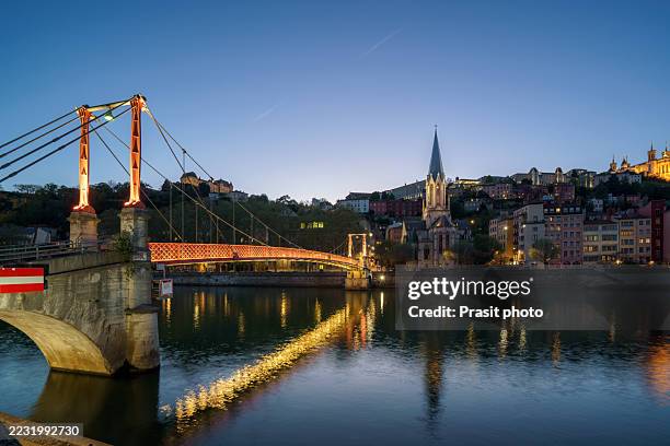 evening view of lyon footbridge and church over rhône river - river rhone stock pictures, royalty-free photos & images