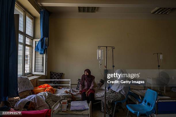 Wahida waits for an appendectomy with her mother Golsoom , while Bibi Hawa recovers in a bed at the government-run regional hospital on August 23 in...
