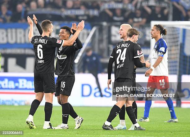 St Pauli's Japanese midfielder Joel Chima Fujita celebrates with St Pauli's US midfielder James Sands after the German first division Bundesliga...