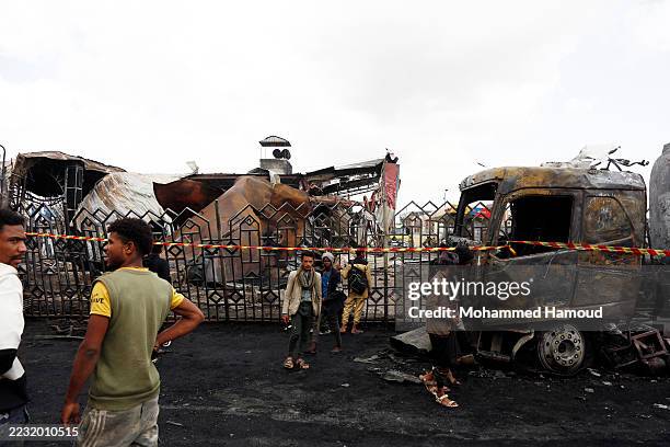 Residents inspect a fuel station struck by aerial attacks carried out by Israeli fighter planes, on August 25, 2025 in Sana'a, Yemen. The Israeli...