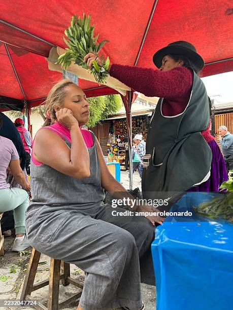 indigenous vendors selling herbs at a traditional market in cuenca, ecuador - traditional native american medicine stock pictures, royalty-free photos & images