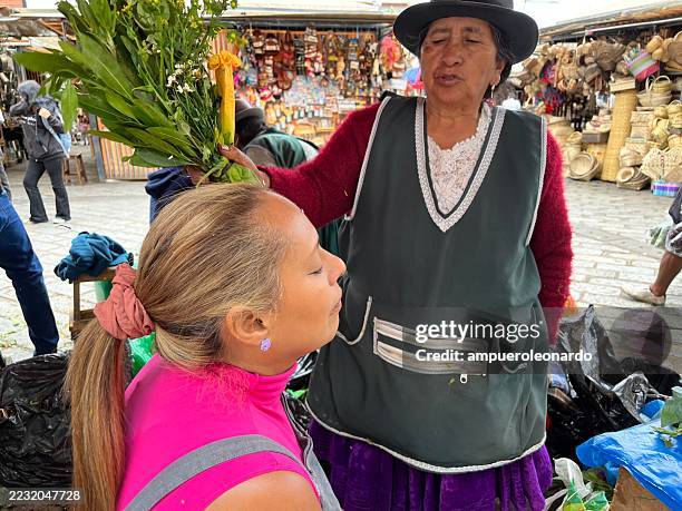 indigenous vendors selling herbs at a traditional market in cuenca, ecuador - traditional native american medicine stock pictures, royalty-free photos & images