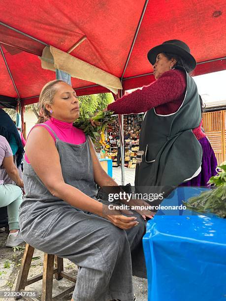 indigenous vendors selling herbs at a traditional market in cuenca, ecuador - traditional native american medicine stock pictures, royalty-free photos & images