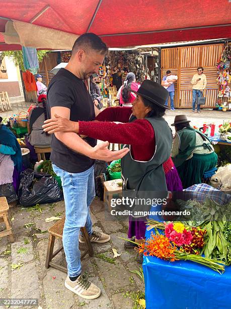 indigenous woman performing cleansing ritual with herbs in cuenca, ecuador - traditional native american medicine stock pictures, royalty-free photos & images