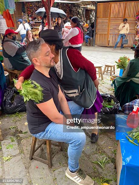indigenous woman performing cleansing ritual with herbs in cuenca, ecuador - traditional native american medicine stock pictures, royalty-free photos & images