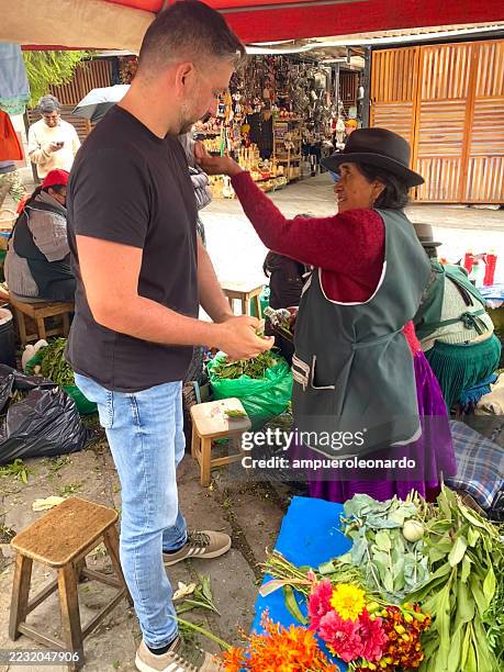 indigenous woman performing cleansing ritual with herbs in cuenca, ecuador - traditional native american medicine stock pictures, royalty-free photos & images