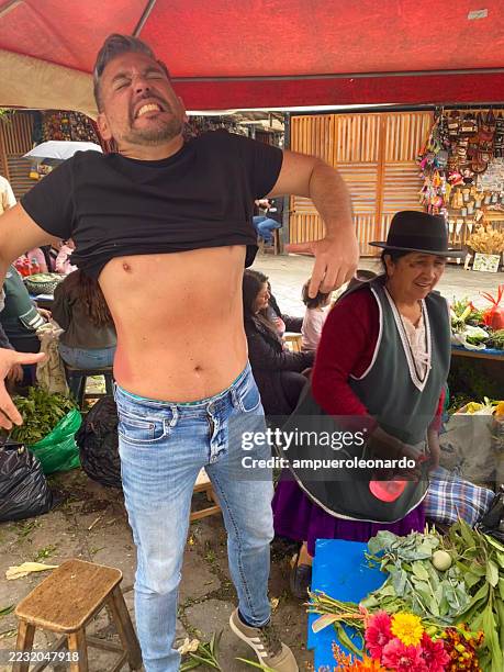 indigenous woman performing cleansing ritual with herbs in cuenca, ecuador - traditional native american medicine stock pictures, royalty-free photos & images