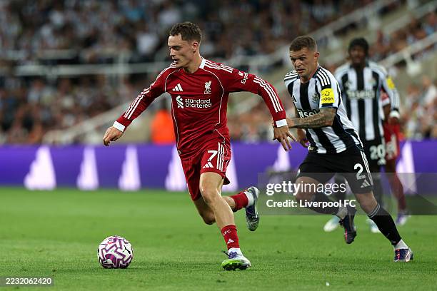 Florian Wirtz of Liverpool runs with the ball whilst under pressure from Kieran Trippier of Newcastle United during the Premier League match between...