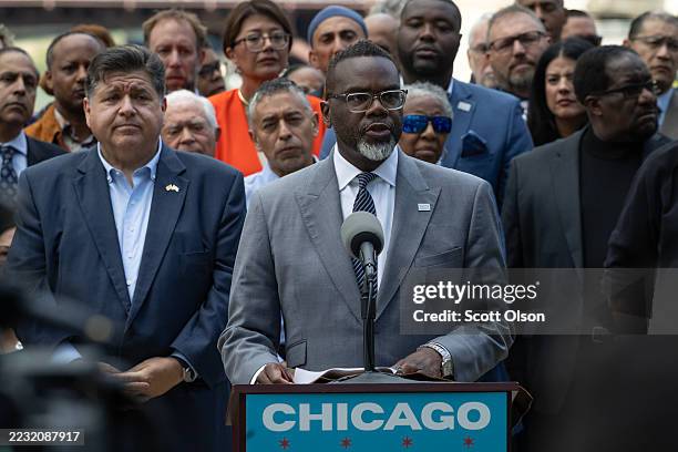 Flanked by Illinois Gov. JB Pritzker and other Illinois politicians and community leaders, Chicago Mayor Brandon Johnson speaks at a news conference...