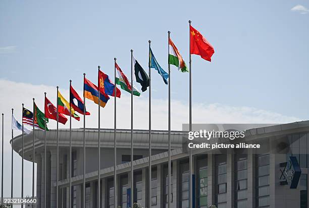 August 2025, China, Tianjin: The flag of China flies alongside the flags of India, Kazakhstan, Pakistan and other countries represented at the...