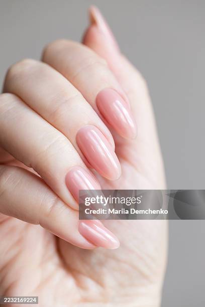hand with pink gel nails manicure - gel nail polish stock pictures, royalty-free photos & images