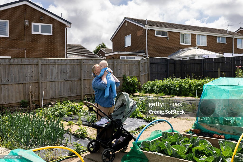 Mother Holding Baby at Family Allotment