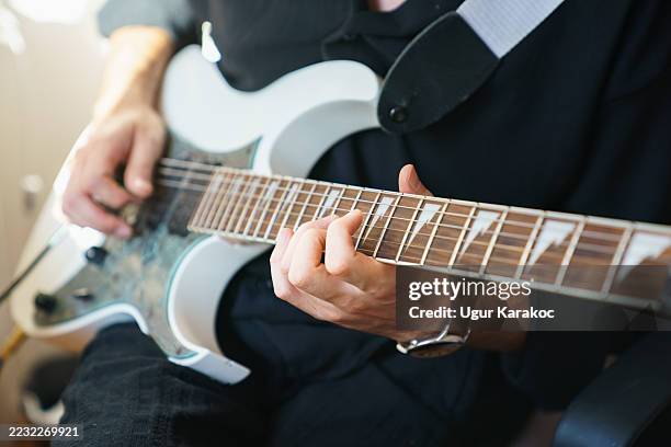 guitarist playing electric guitar - electric guitar stock pictures, royalty-free photos & images