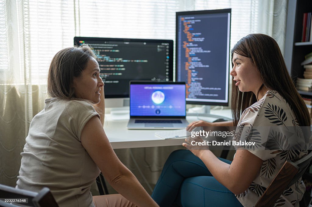 Two Female Programmers Learning To Code In Modern Office Using AI