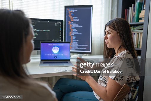Two Female Programmers Learning To Code In Modern Office Using AI Two Female Programmers Learning To Code In Modern Office Using AI