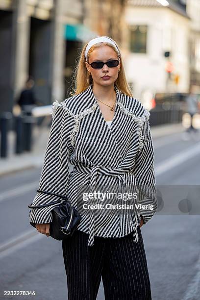 Sofie Vollan wears white head band, white black stripped jacket, striped pants during Oslo Fashion Week on August 26, 2025 in Oslo, Norway.