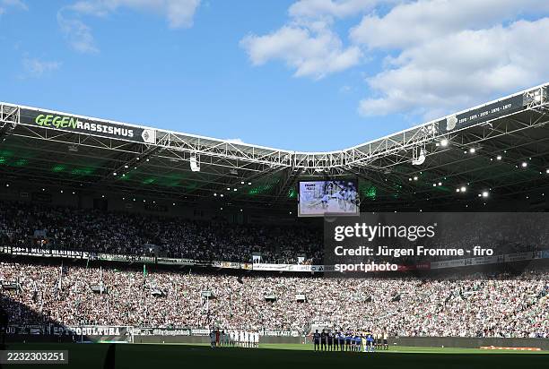 Borussia Mönchengladbach team and FAns Minute's silence in mourning for former Gladbach player Frank Mill before the Bundesliga match between...
