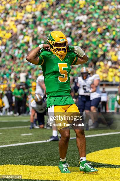 Dante Moore of the Oregon Ducks celebrates a touchdown with Jordon Davison of the Oregon Ducks during the second quarter against the Montana State...